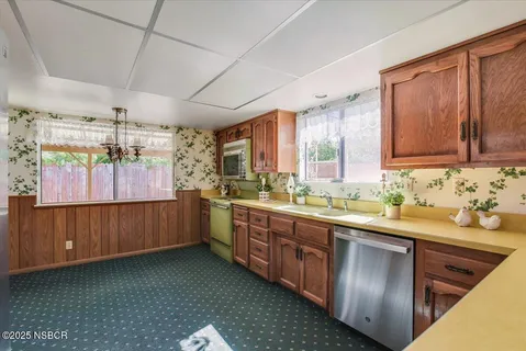 a kitchen with sink cabinets and window