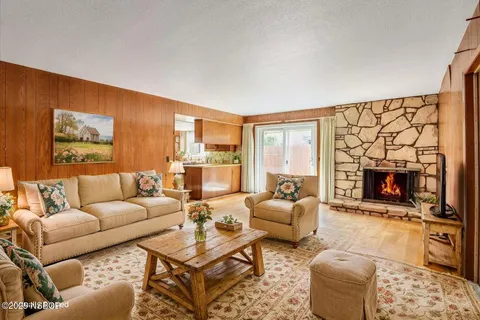 a view of an empty room with a fireplace and a window