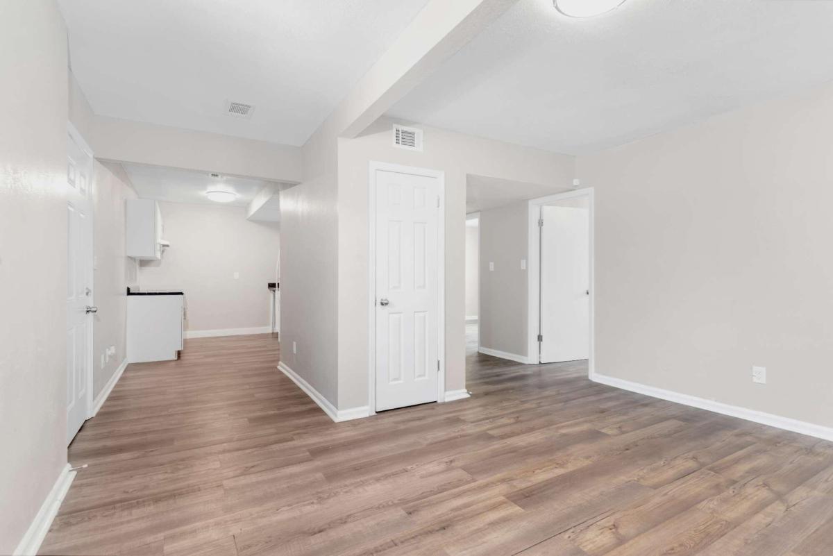a view of a hallway with wooden floor