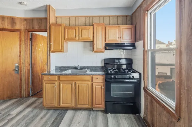 a kitchen with stainless steel appliances granite countertop a refrigerator and a stove