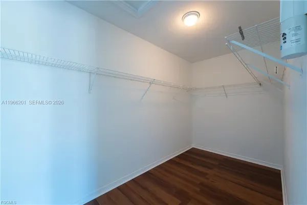 a view of a room with wooden floor