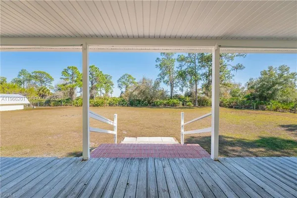 a view of a balcony with yard