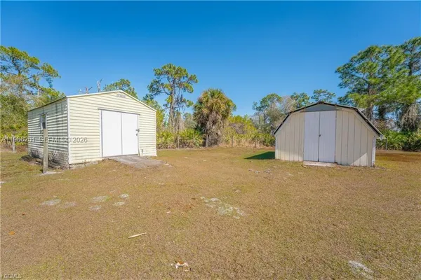 a view of a house with a backyard and a garage