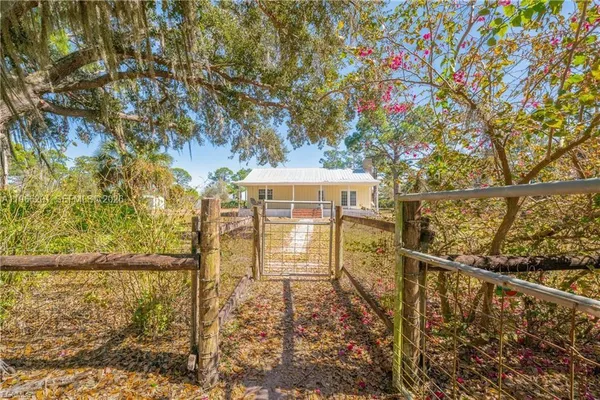 a view of balcony with wooden floor and fence