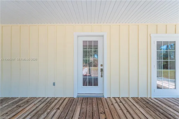 a view of a room with wooden floor and windows