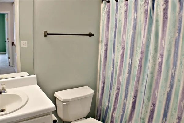 a white toilet sitting next to a bathroom sink