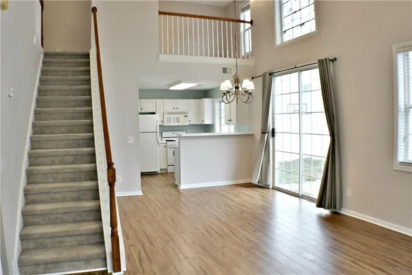 a view of a hallway with wooden floor and staircase