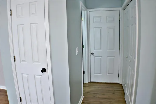 a view of a hallway with wooden floor