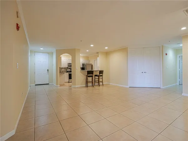 a kitchen with kitchen island cabinets and chairs in it
