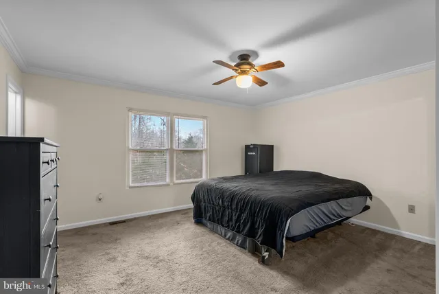 a bedroom with a bed next to a window