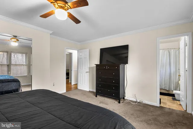 a bedroom with a bed and a flat tv screen