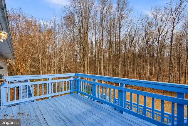 a view of a wooden chairs on the deck
