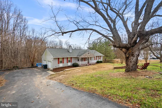 a white house that has a tree in front of it