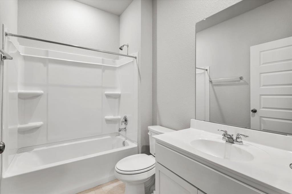 12212 Dillon Fls Drive Austin, TX 78747 - Photo 21 of 40 Full bathroom featuring bathing tub / shower combination, vanity, and light tile patterned floors