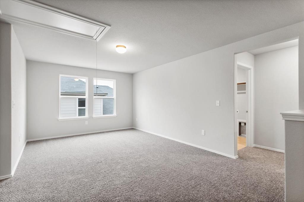 12212 Dillon Fls Drive Austin, TX 78747 - Photo 22 of 40 Carpeted empty room featuring attic access and a textured ceiling