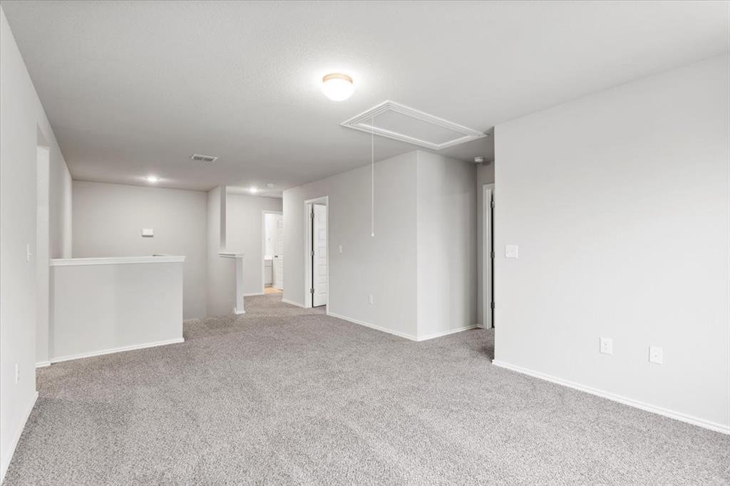 12212 Dillon Fls Drive Austin, TX 78747 - Photo 23 of 40 Spare room with light carpet and attic access