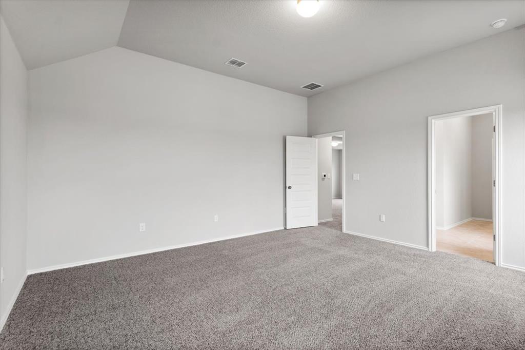 12212 Dillon Fls Drive Austin, TX 78747 - Photo 27 of 40 Unfurnished bedroom with carpet and vaulted ceiling