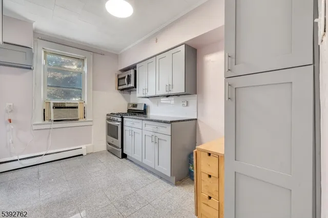 a view of a room with wooden floor and window
