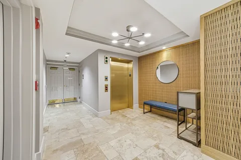 a view of a livingroom with wooden floor and a ceiling fan