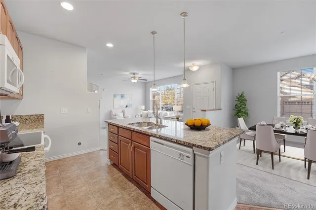 a kitchen with cabinets and chairs