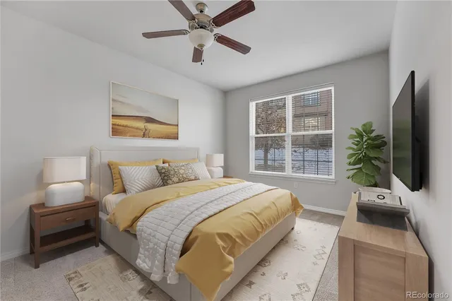 a bedroom with a large bed and a flat tv screen on dresser