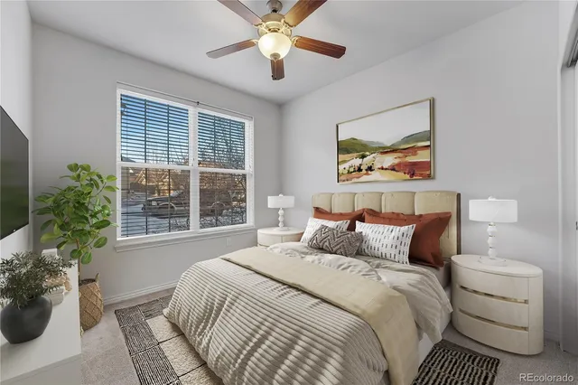 a bedroom with a bed and a large window