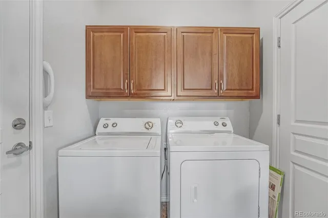 a view of storage and utility room with washer and dryer