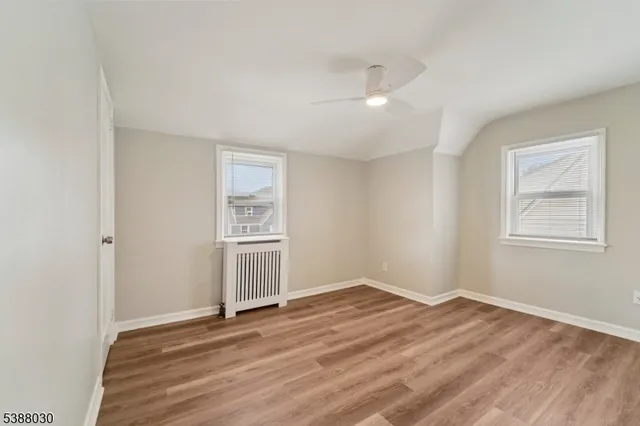 a view of a room with wooden floor and window