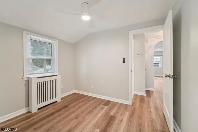 a view of a room with wooden floor cabinet and windows