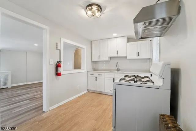 a kitchen with a stove a sink and a refrigerator