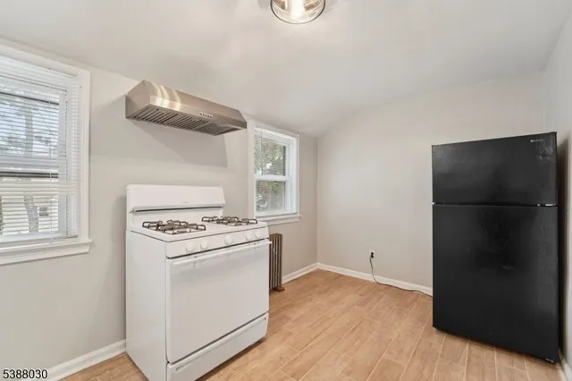 a kitchen with a stove and a refrigerator