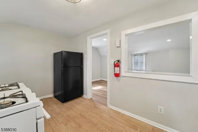 a bedroom with a bed and a refrigerator