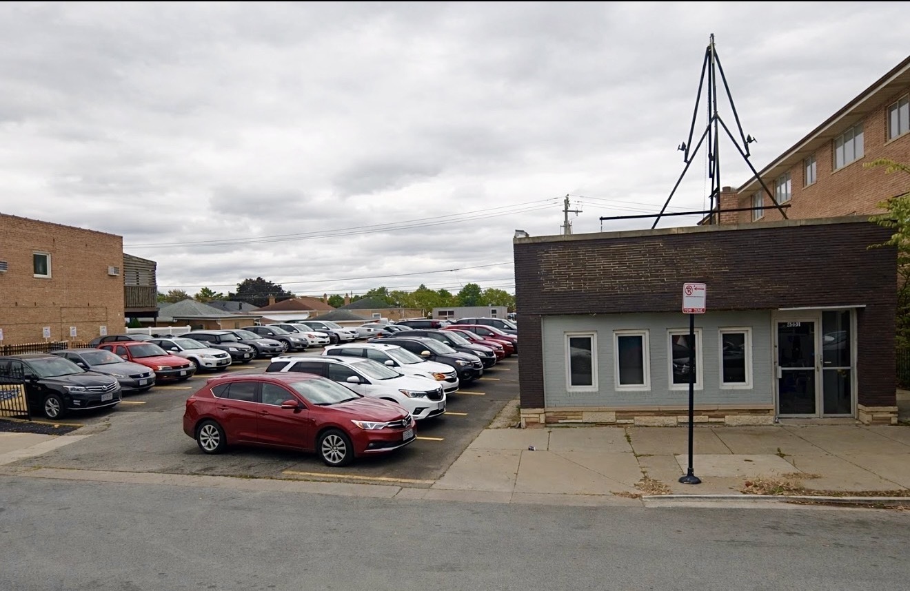 a view of a cars park in front of house