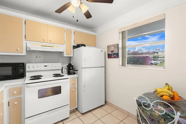a white refrigerator freezer sitting inside of a kitchen