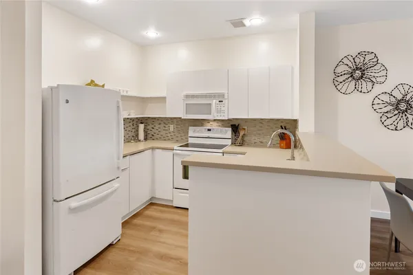 a white refrigerator freezer sitting inside of a kitchen