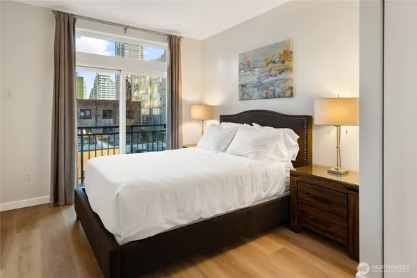 a large bed sitting in a bedroom next to a window