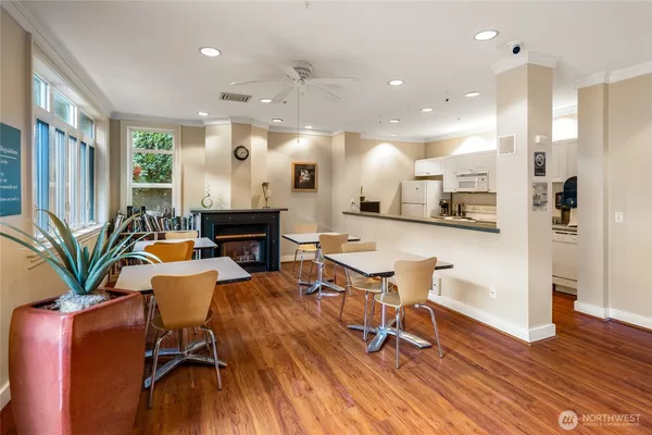 a living room with furniture a wooden floor dining table and a chandelier