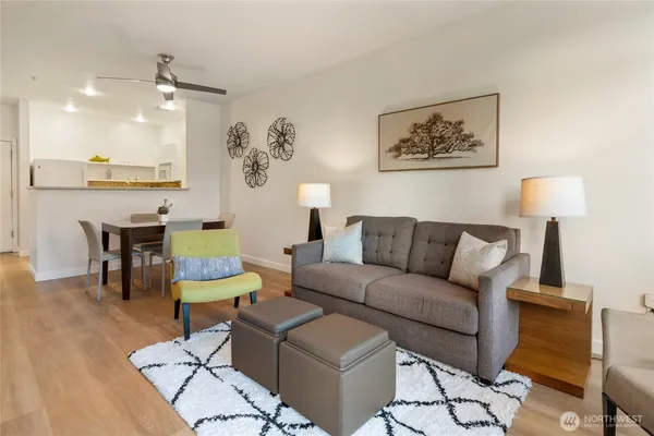 a living room with furniture and a wooden floor