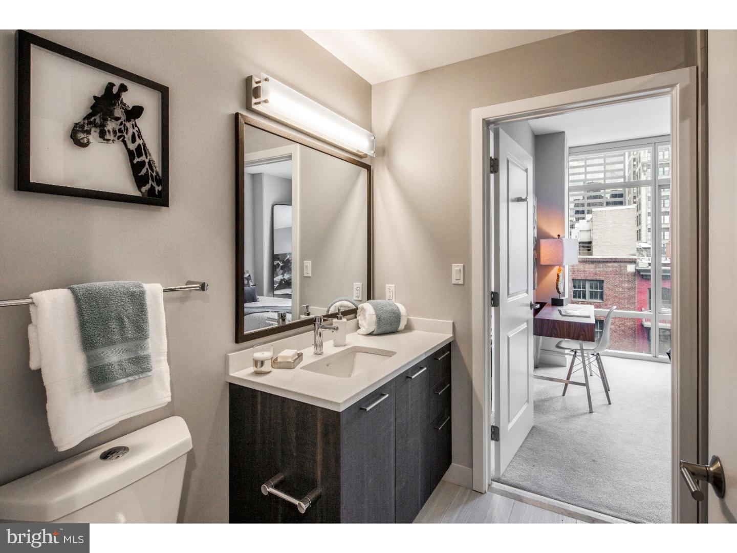 1213 Walnut Street, Unit 1B0301 Philadelphia, PA 19107 - Photo 6 of 10 a bathroom with a sink vanity and a mirror