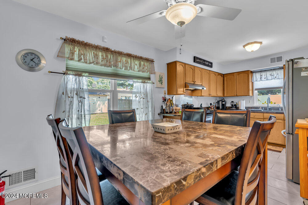 3 Ash Road Jackson, NJ 08527 - Photo 9 of 21 a dining room with wooden floor a chandelier a wooden table and chairs