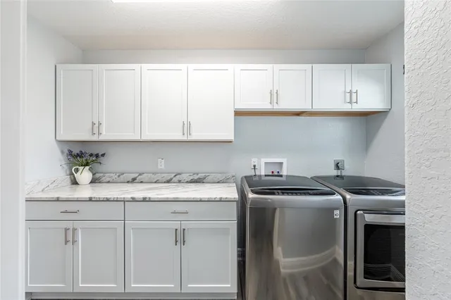 a kitchen with granite countertop white cabinets sink and dishwasher