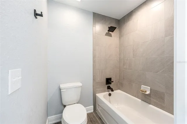a bathroom with a toilet sink and shower