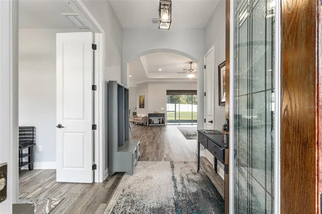 a view of a hallway with living room and dining room