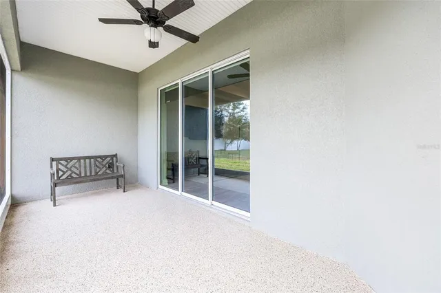 a large white bed in a room next to a window