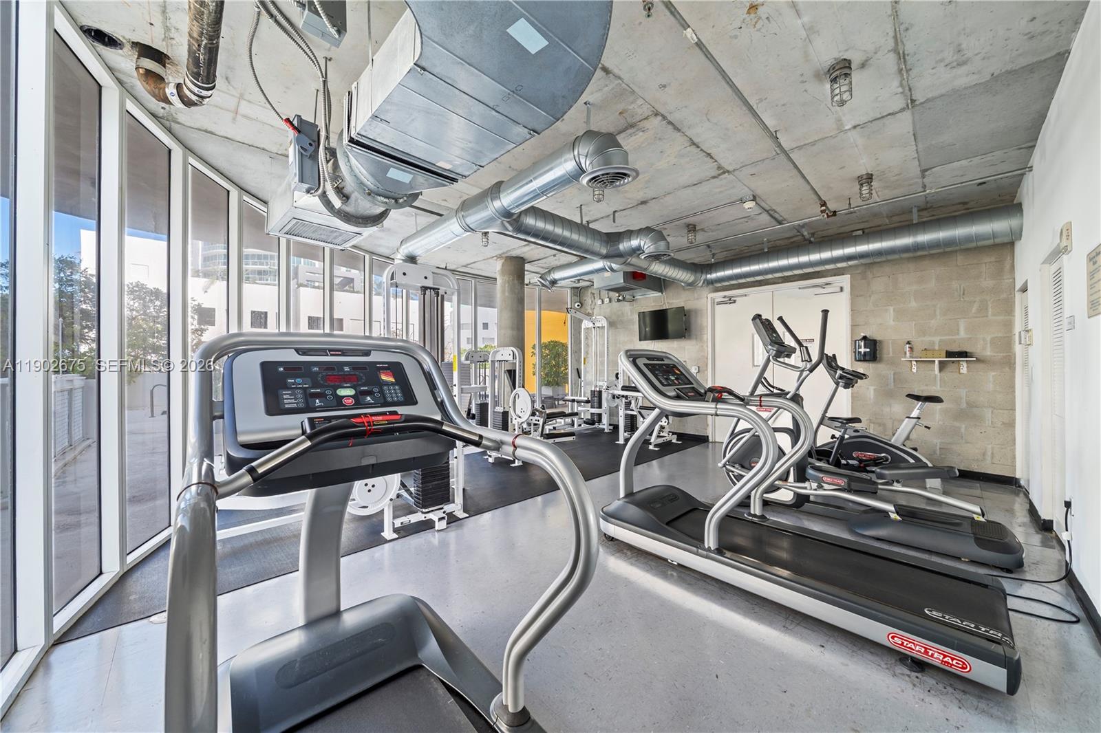 444 Northeast 30th Street, Unit 702 Miami, FL 33137 - Photo 17 of 19 a view of a room with gym equipment