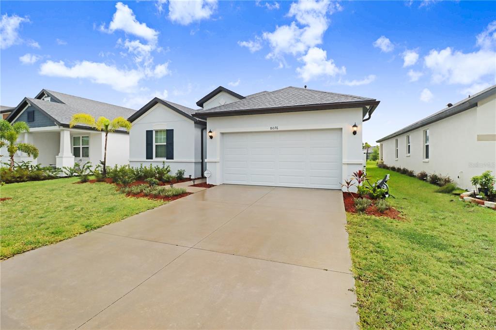 a front view of house with yard and green space