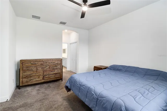 a bedroom with a bed and a dresser