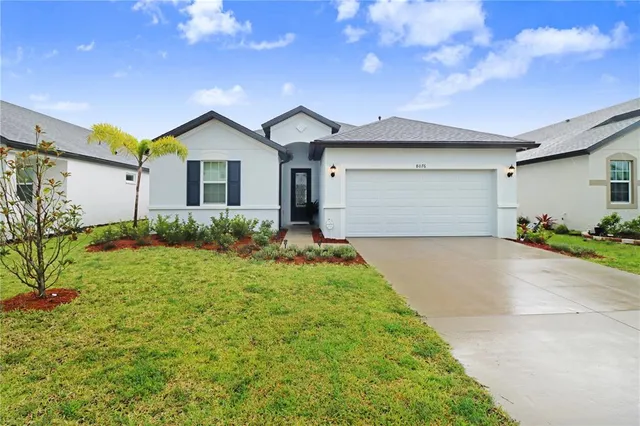 a view of a house with yard and plants