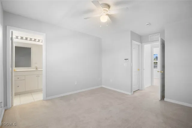 a view of an empty room with a fan