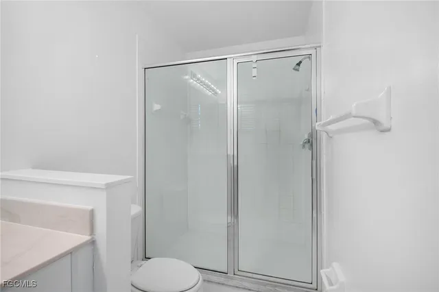 a bathroom with a shower toilet and sink